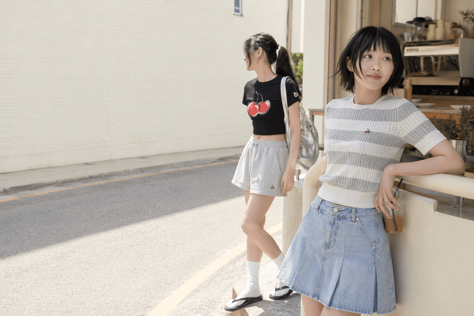 Model in KIRSH cherry graphic crop top and sporty casual styling